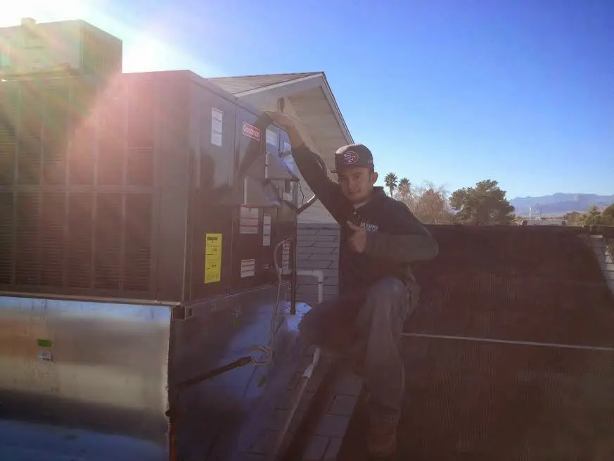 HVAC technician performing AC Tune-Up on a rooftop unit in Cusseta-Chattahoochee County